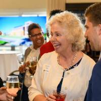 two alumni introduce themselves to Marcia